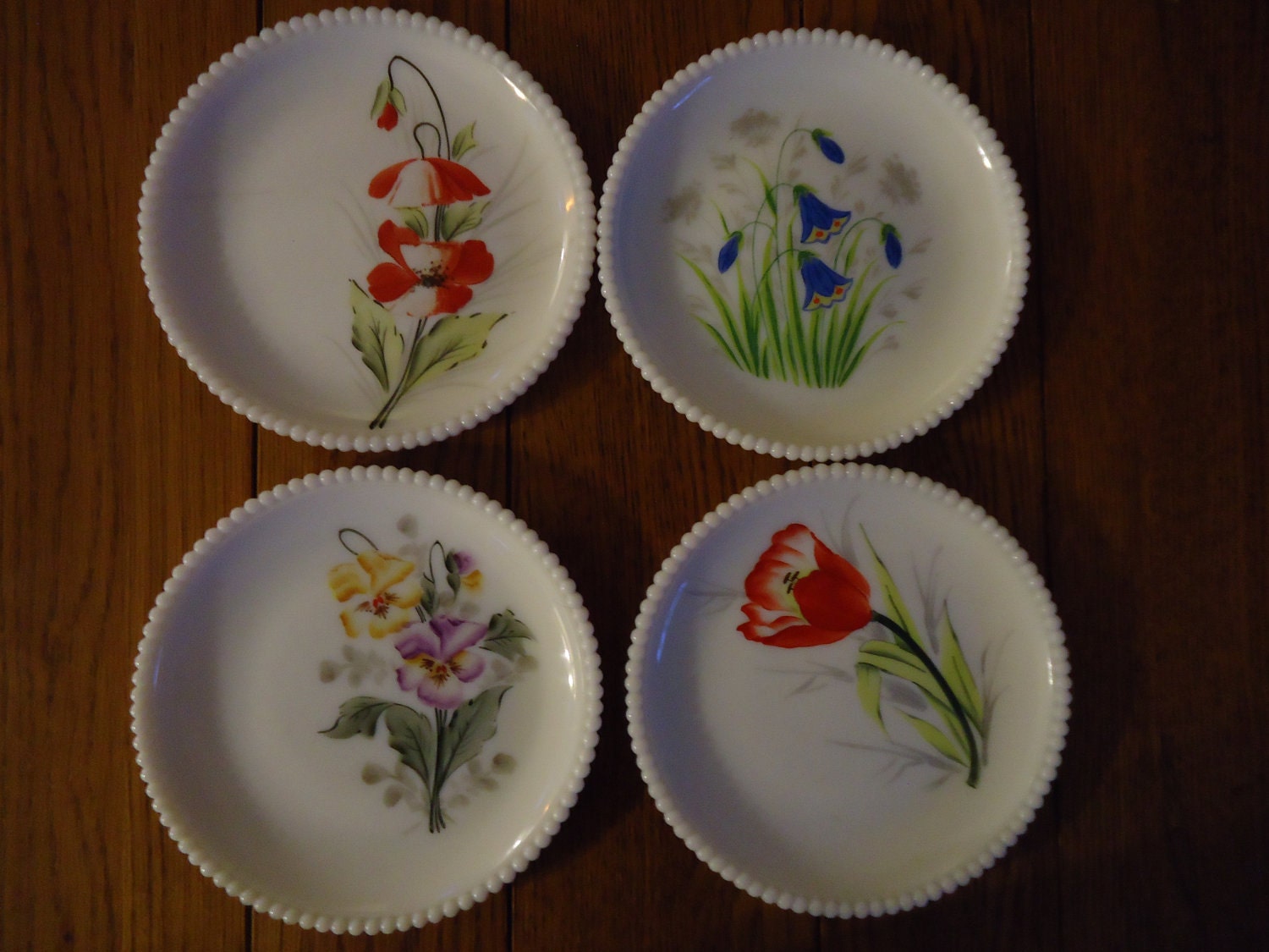 Set of 4 painted milk glass plates by Westmoreland