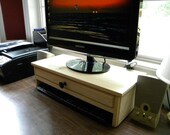 Computer monitor stand with drawer for extra storage and hidden hole in drawer back for cell phone chargers