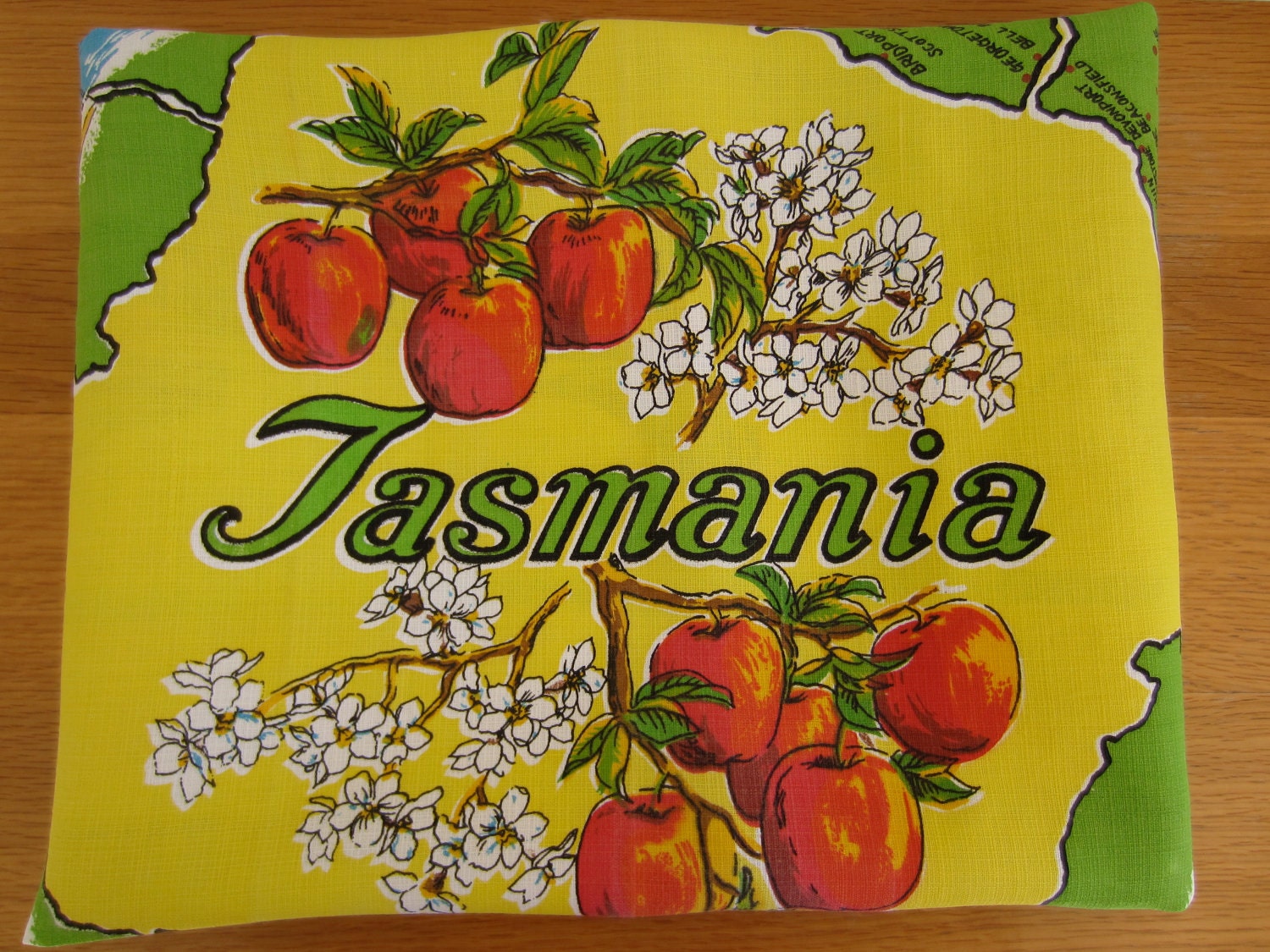 Vintage souvenir tablecloth, Tasmania, yellow and green with red apples and four maps. Square tablecloth