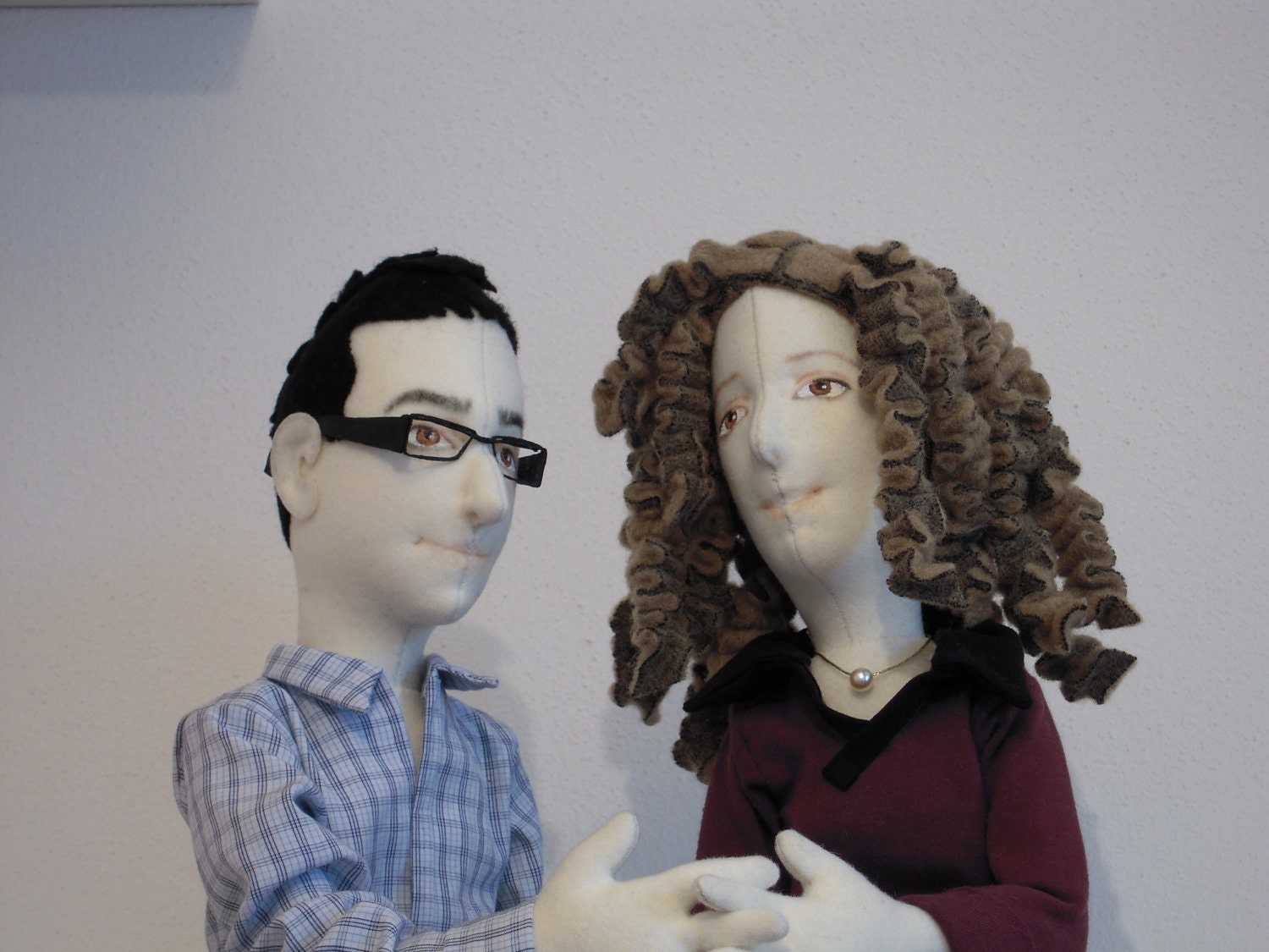 A couple of portrait dolls in cloth.