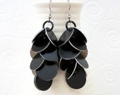 Bold chainmail earrings, shaggy black metal disks