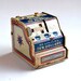 Vintage J. Chein & Co. tin litho Dime Register Bank 2 inches tall  offered by Elizabeth Rosen