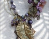 LILAC LIMERICK--Pastel shades in a light creation of hand-dyed silk flowers, Amethyst, Peridot and polymer leaves.