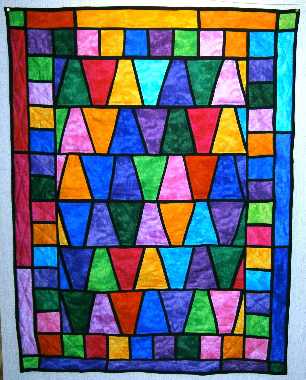 Stained Glass Wonder Quilt 40 in. W x 52 in L              using Tumbler template and has a hanging sleeve on back