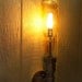 Wall Lamp. Beer bottle, Plumbing pipe & fittings. Wall light. Lighting Fixture. Sconce