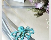 Sea Green Faux Patina Brass Octopus Pendant on a gold finished brass chain