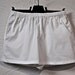 white cotton shorts with elastic rubber-band belt. size 12, waist up to 32 inches