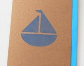 Cute blank greeting card featuring a hand stamped boat in blue on kraft card