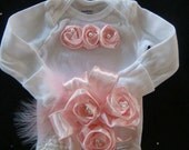 Baby girl outfit onesie bodysuit romper beautiful soft satin pink rosette ribbon adorn this outift accented with pearls and feathers.