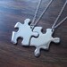 Two Silver Puzzle Piece Pendants