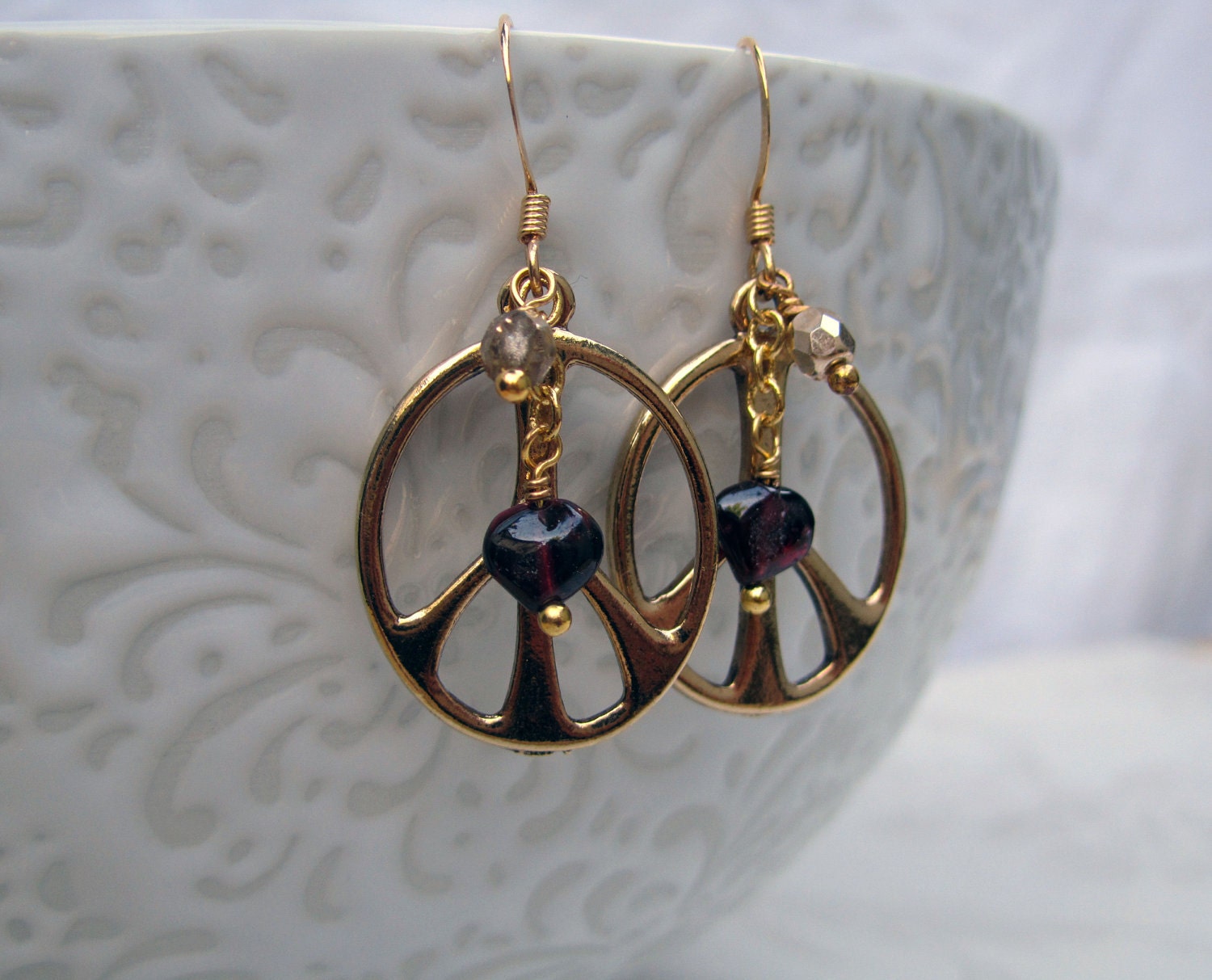 Hippie chick gold plated peace sign earrings with gold and heart shaped garnet beads