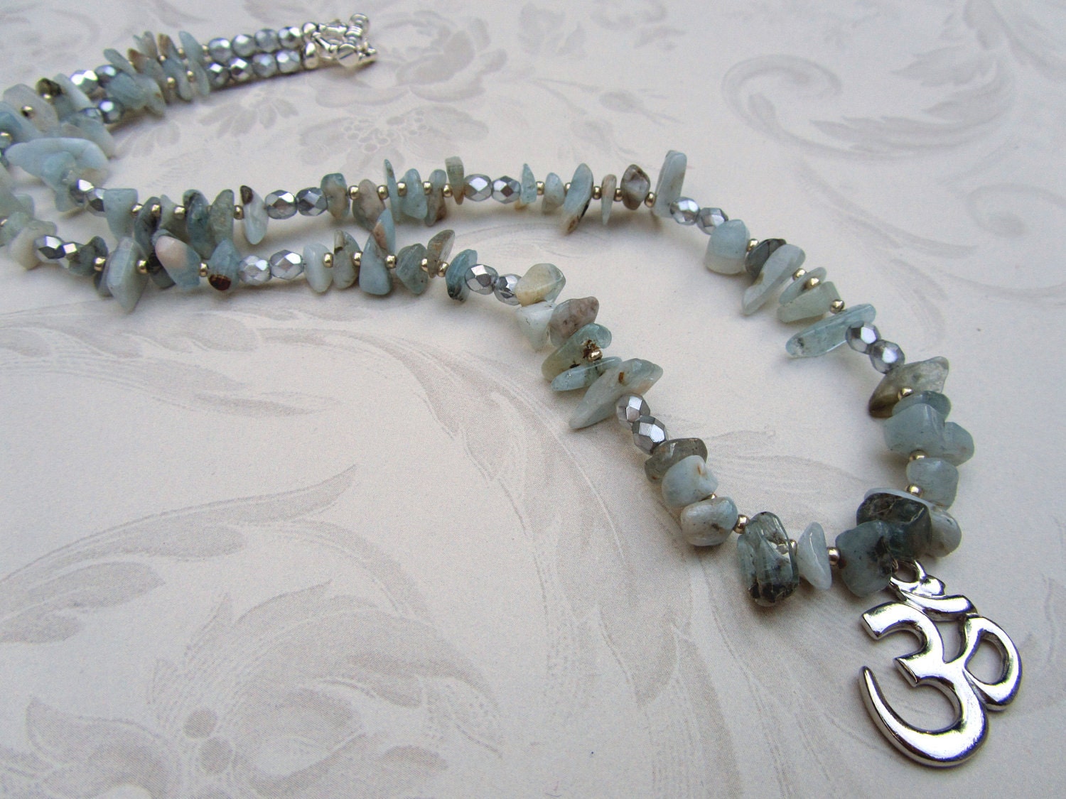 Silver plated Om pendant on aquamarine beaded boho yoga necklace