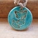 Butterfly pendant, bronze and turquoise crackle glaze, tied with a butterscotch vintage velvet ribbon