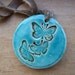 Butterfly pendant, bronze and turquoise crackle glaze, tied with a butterscotch vintage velvet ribbon