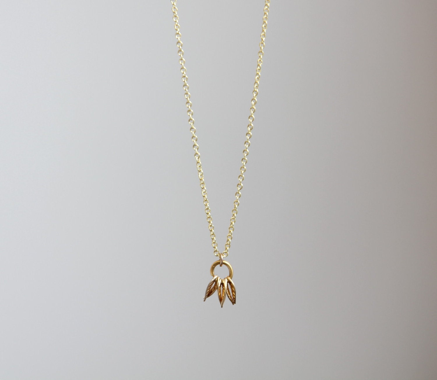 Delicate simple everyday gold tiny leaf cluster pendant necklace