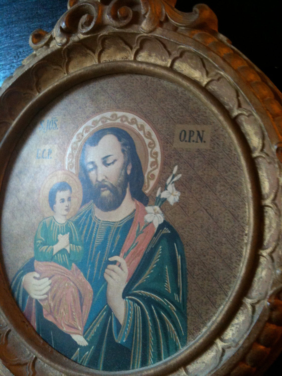 Small round religious print in frame