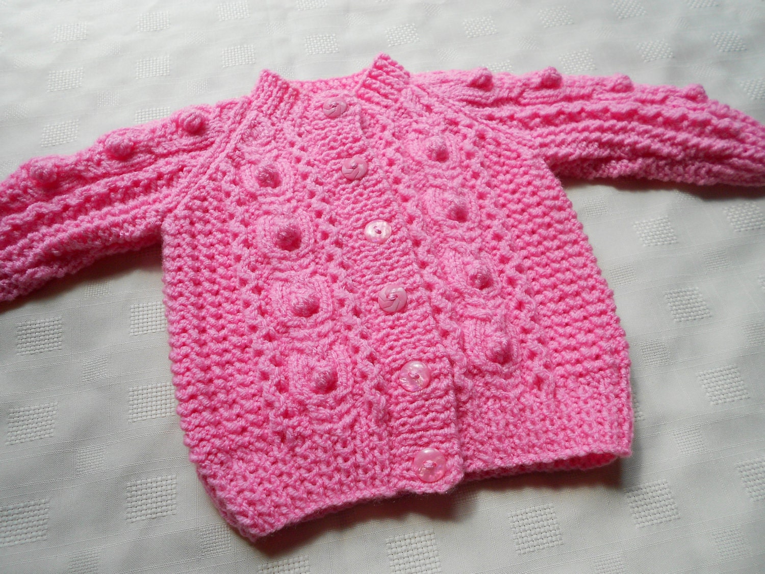 Baby girl sweater in pink, hand knit