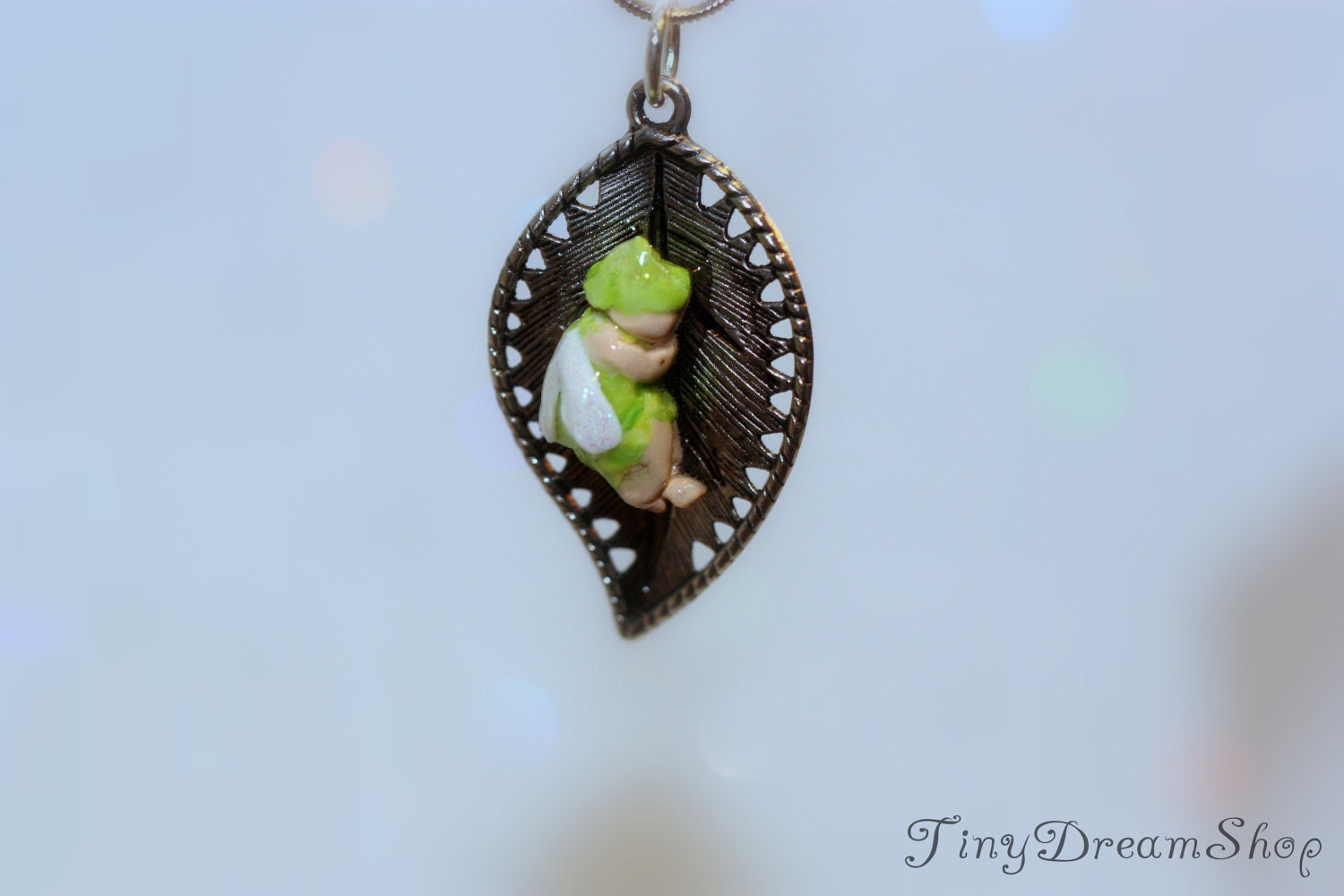 SALE: Pixie with Me necklace featuring a sweet, micro miniature pixie sleeping on a metal leaf