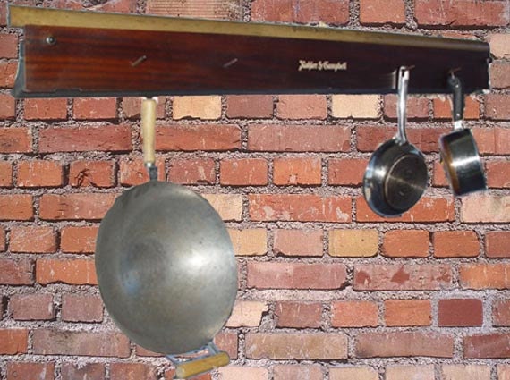 Upcycled hanging pot and pan rack created from antique piano parts
