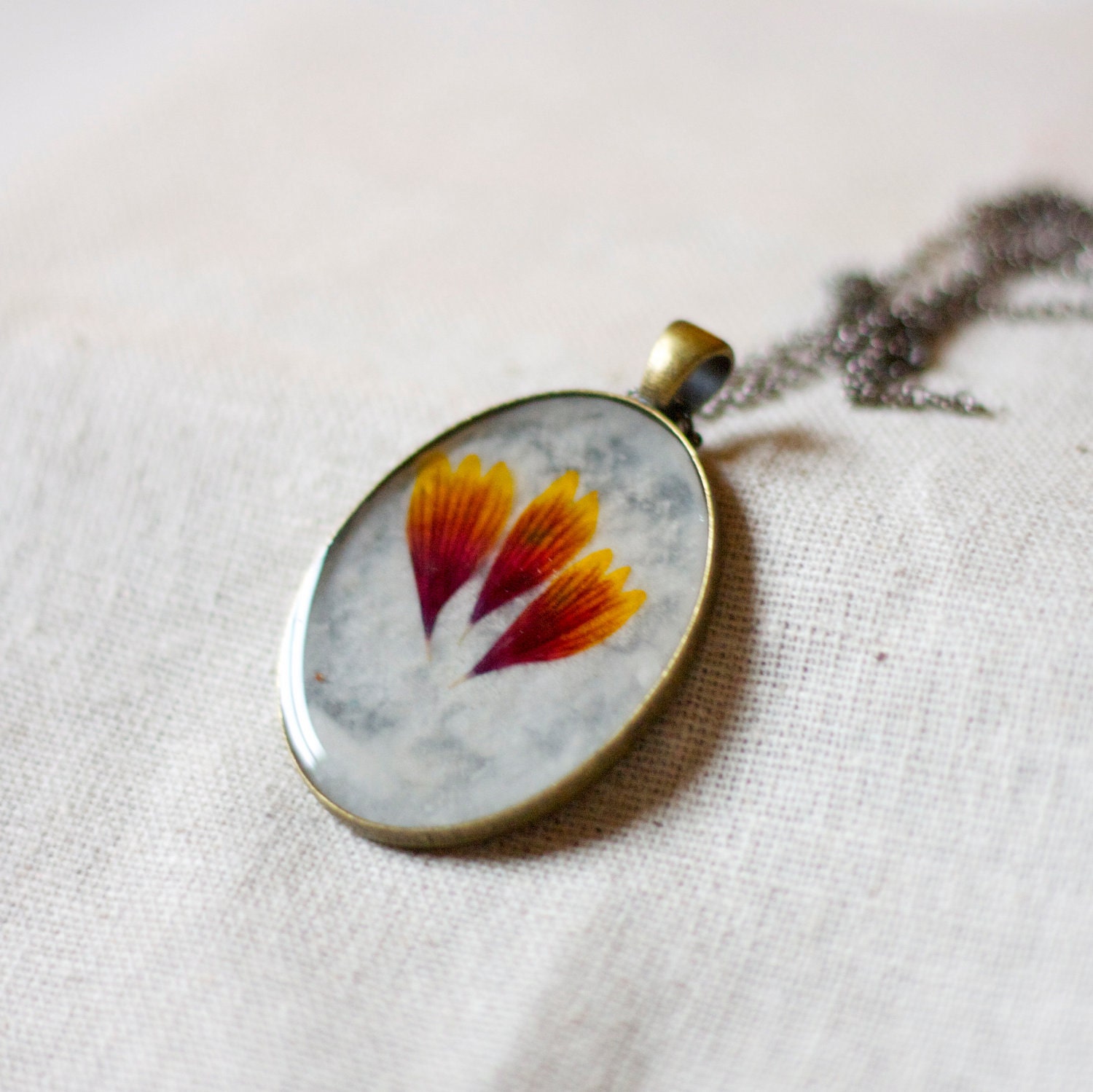 handmade pressed flower necklace in resin natural botanical wildflower zinnia petals red and gold autumn garden pendant