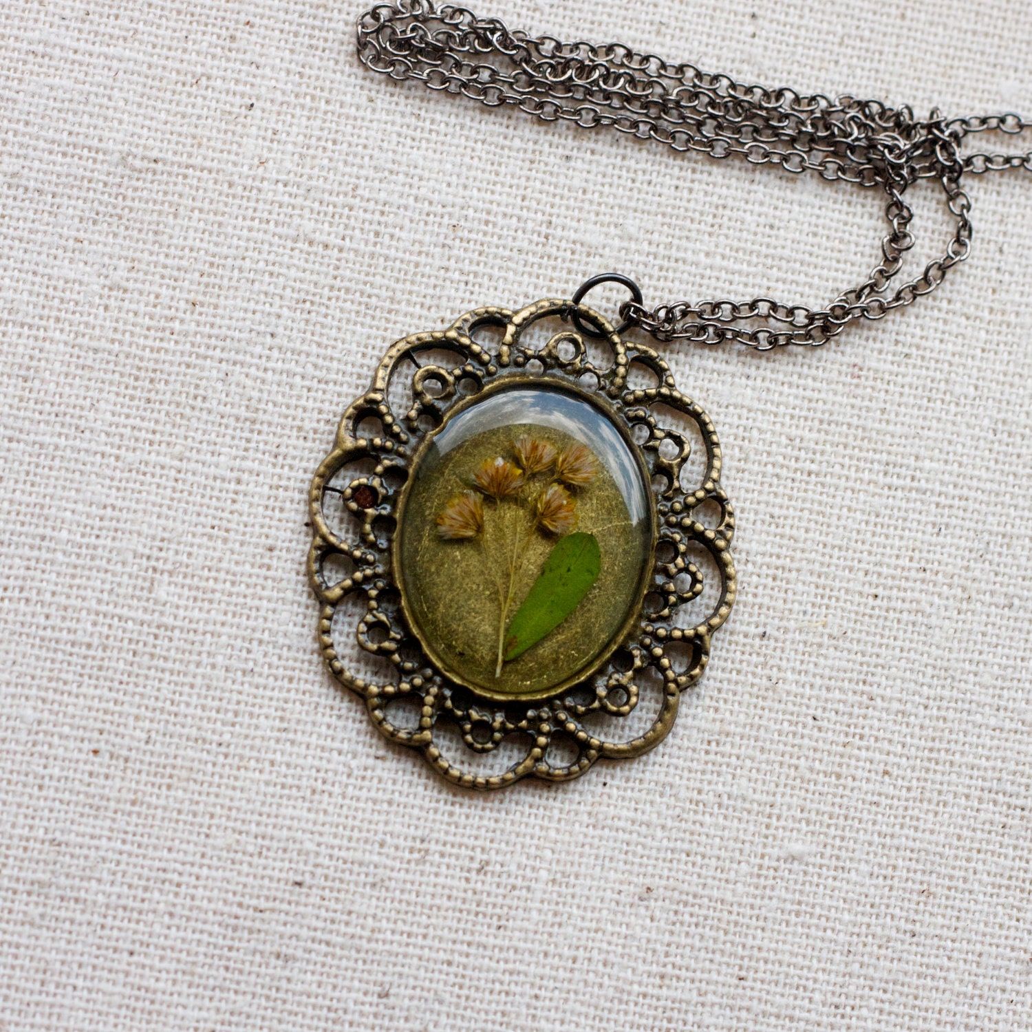 pressed flower necklace resin dried brown wildflower set in resin. cottage chic oval filigree pendant for summer. prairie.
