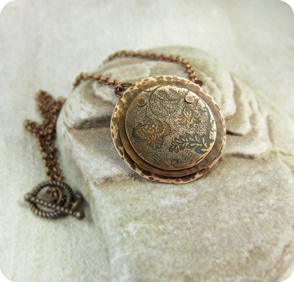 Copper necklace with flower pattern.