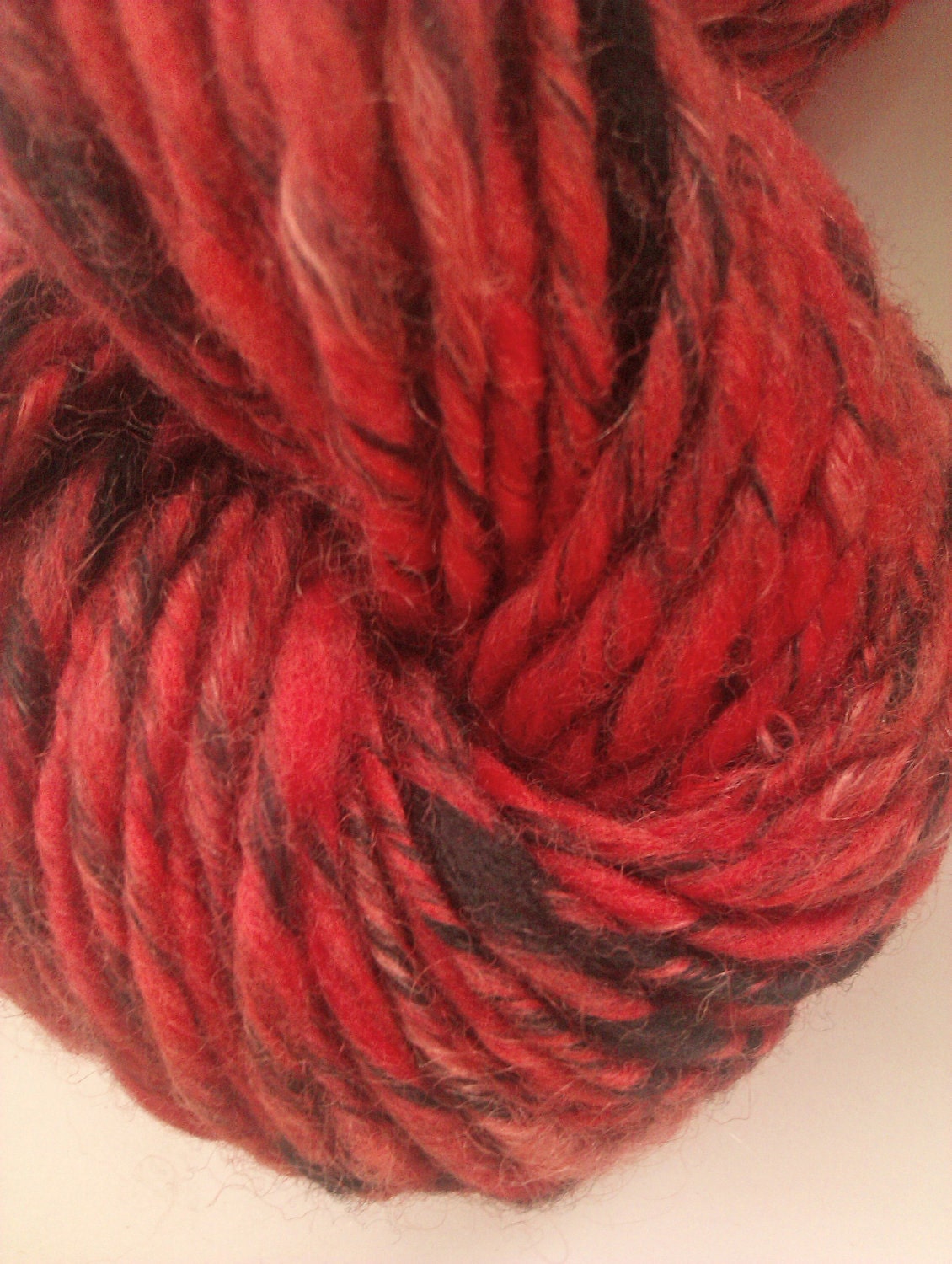 Ruff'n'reddy mohair and merino. Hand spun art yarn. Handspun. Red and black. 21 micron Australian merino wool with Fine kid mohair.