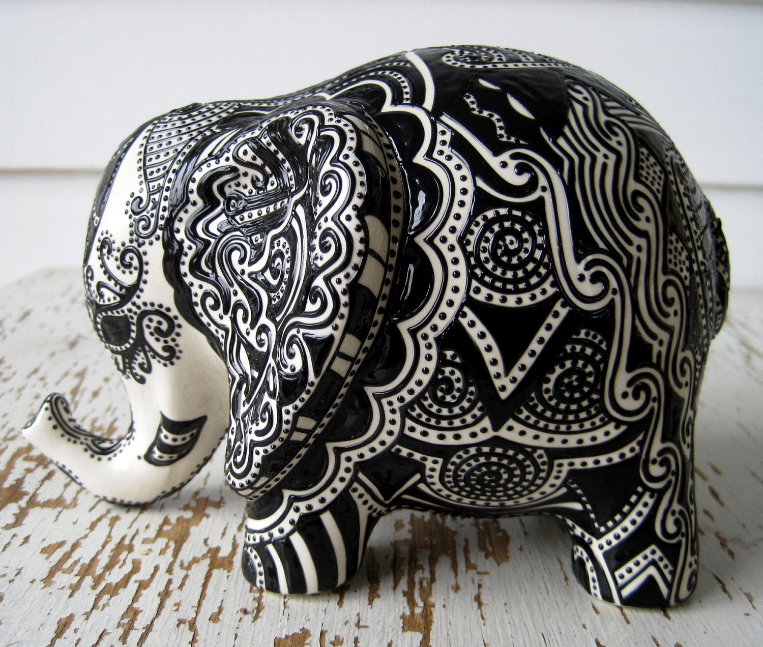 Lucky Elephant Bank -- White Ceramic Elephant with Black Embossed design on top.