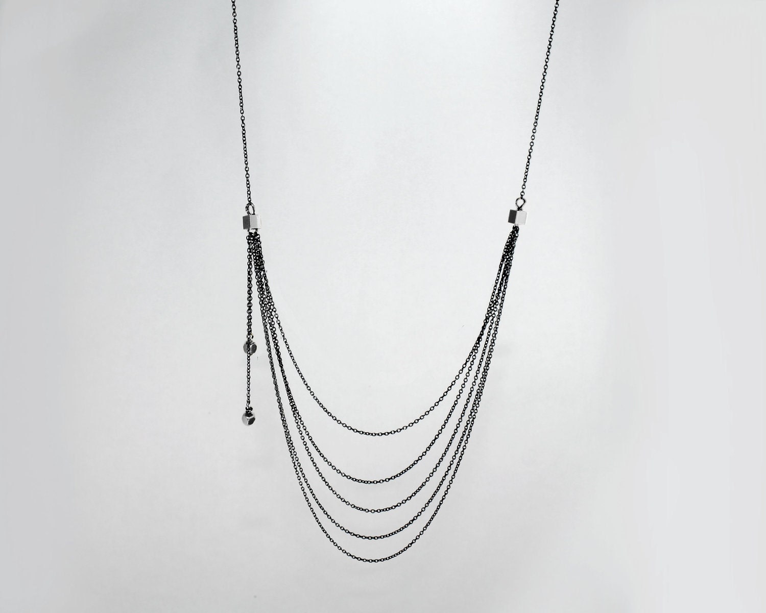 Dauphine D'eau:  Rain  necklace. Cascading layers of gold filled chain and an 18k gold plated rain cloud. A Long multi chain necklace