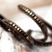 Triple wrap leather bracelet with metallic brown cube beads and gold tone button. No metal. WGC3v004