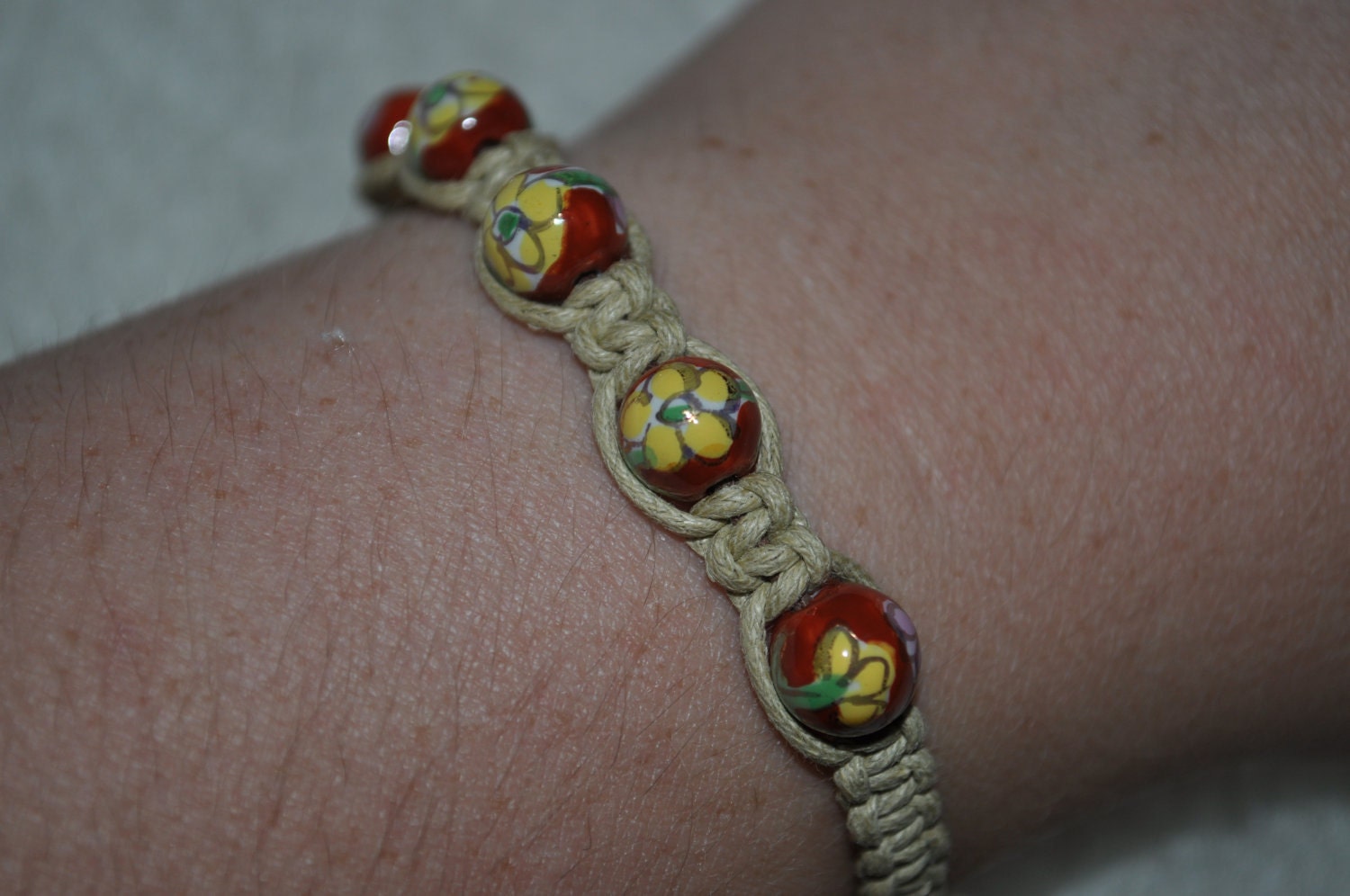 handmade macrame cord bracelet with rust colored cloisonne beads