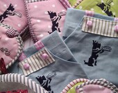 Child's apron , blue, embroidered with scottie dog.