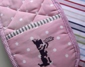 Double oven-glove, pink  . Embroidered with a cheerful scottie dog.