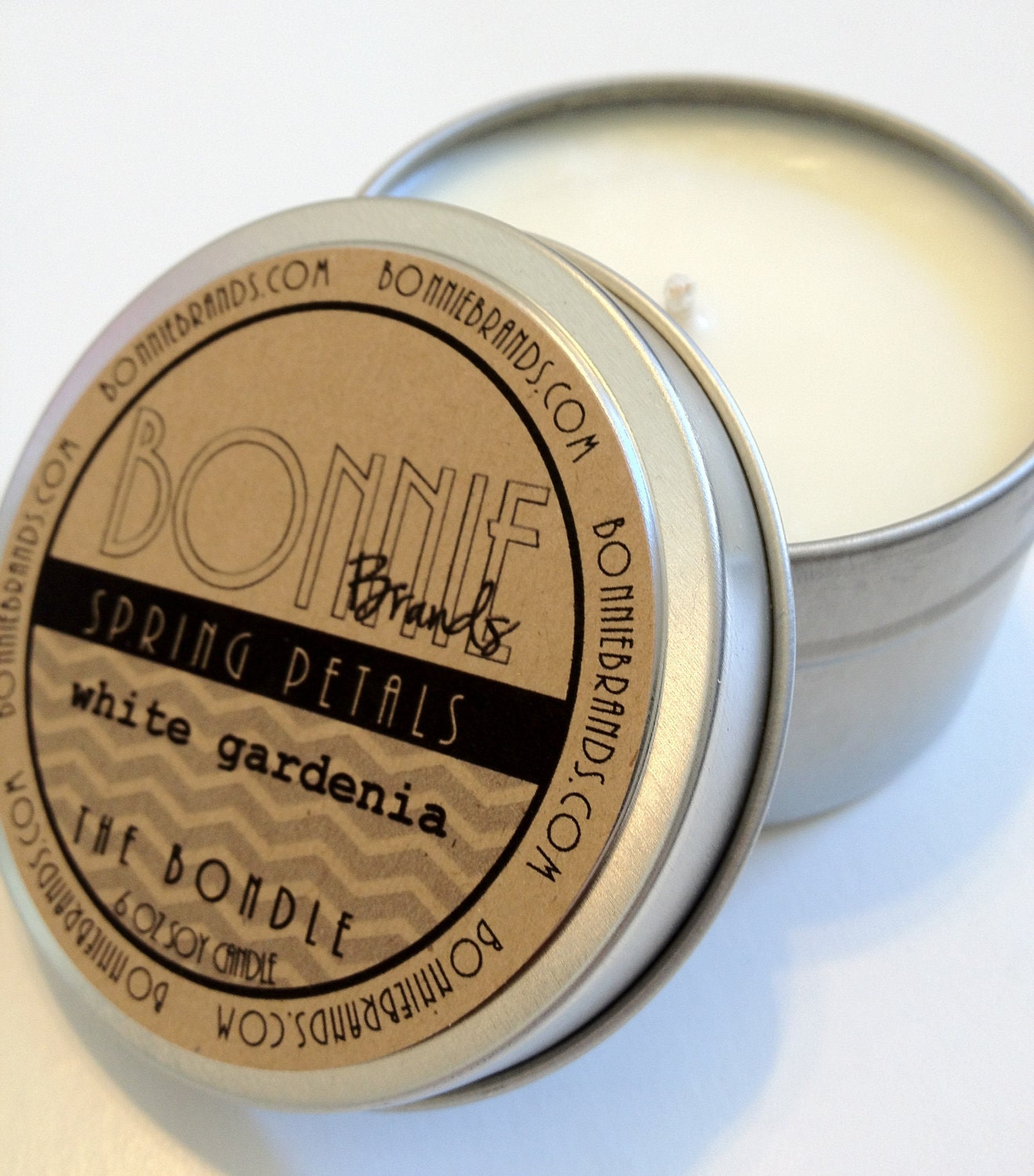 The Bondle: 6 oz Spring Petals Soy Candle flavored with White Gardenia in a Seamless Travel Tin