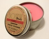 The Bondle: 6 oz Pinky Soy Candle flavored with Japanese Cherry Blossom in a Seamless Travel Tin