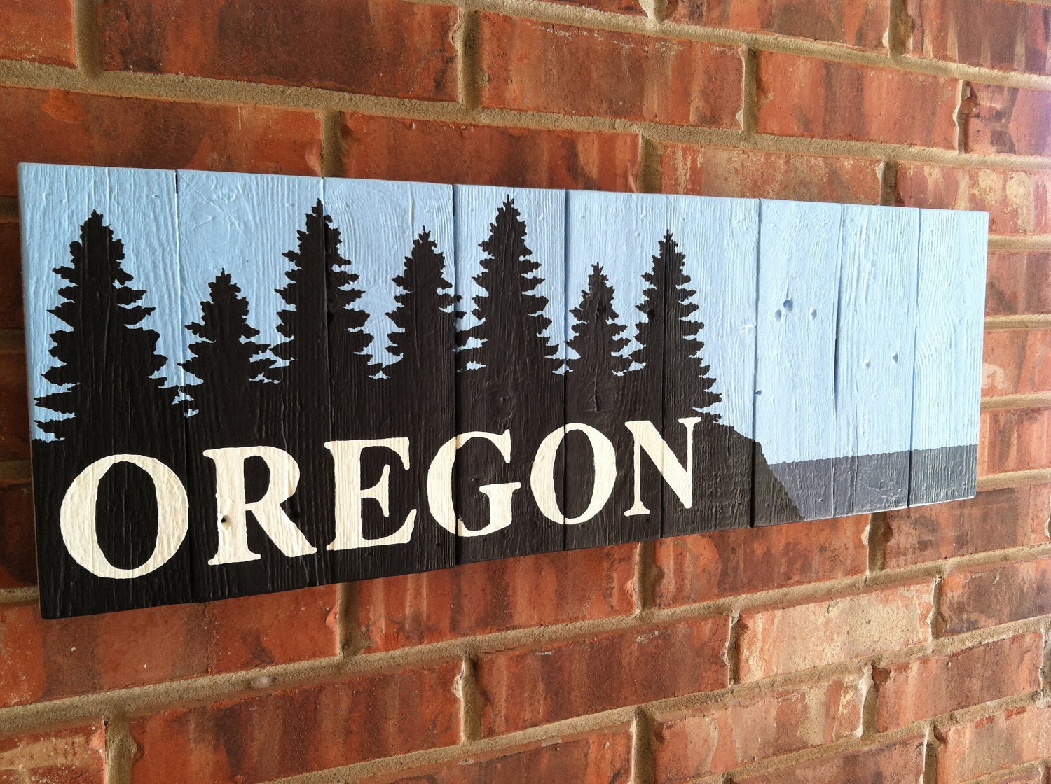 OREGON sign with trees sky and water