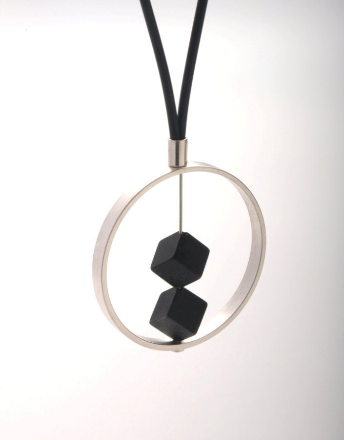 2 DARK pendant. A large palladium-plated ring with 2 black onyx , attached to a black leather necklace.