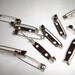 Pin or brooch back 1 inch long 11 pieces