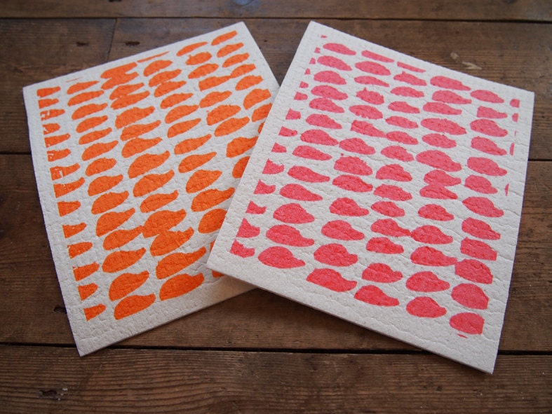 A pair of hand printed "Hundreds & Thousands" dishcloths in orange and pink - biodegradable