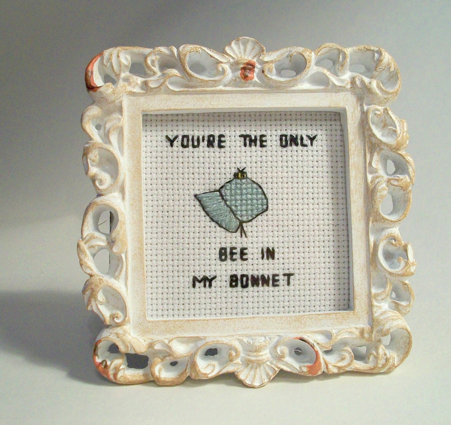 You're the only bee in my bonnet -- TMBG "birdhouse in your soul" lyric in small cross stitch