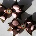 brown and pink monkey pigtail bows