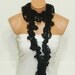 The scarf is knitted with black, soft yarn. Long scarf. Romantic. For her. HAND MADE.