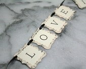 Wedding cake banner, mini bunting. Love is Sweet with vintage sheet music background.
