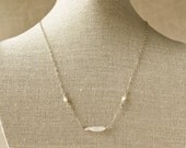 Delicate and feminine this lightly oxidized sterling silver chain necklace is accented with freshwater pearls.