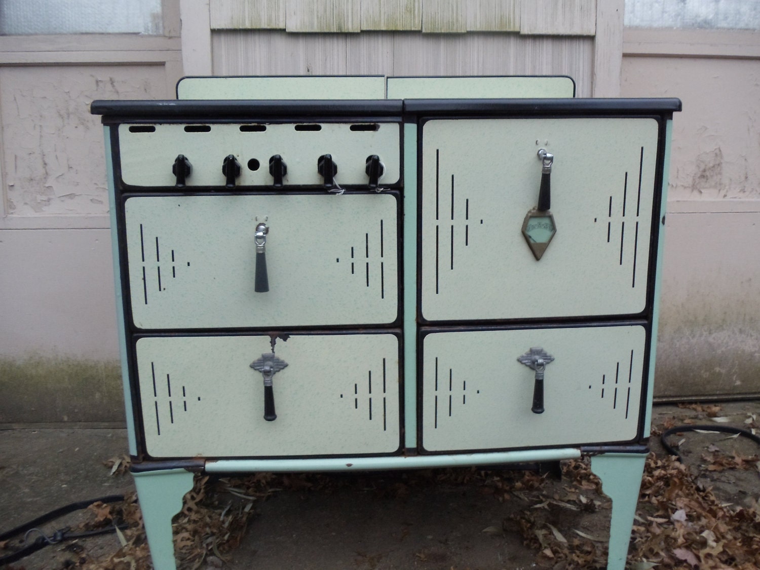 1920 enamel gas stove,  green  and cream with black bakelite handles