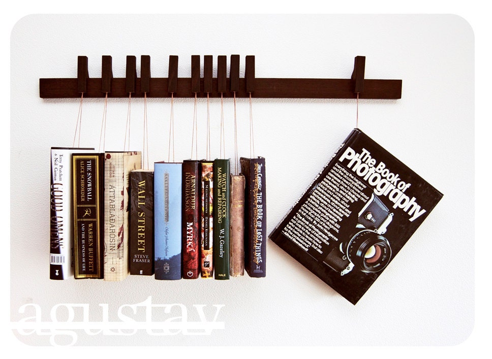Custom made wooden book rack in Wenge. Pins also work as bookmarks.