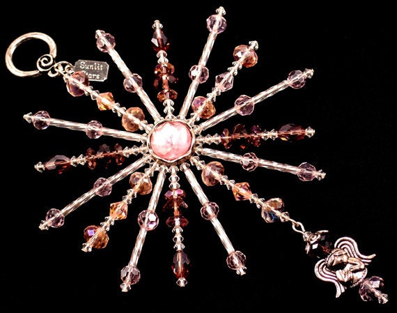 Star of Beauty Ornament is 6" x 4" and handcrafted with a pink center, angel charm, Pink, Amethyst, Swarovski crystals, twisted glass bugles