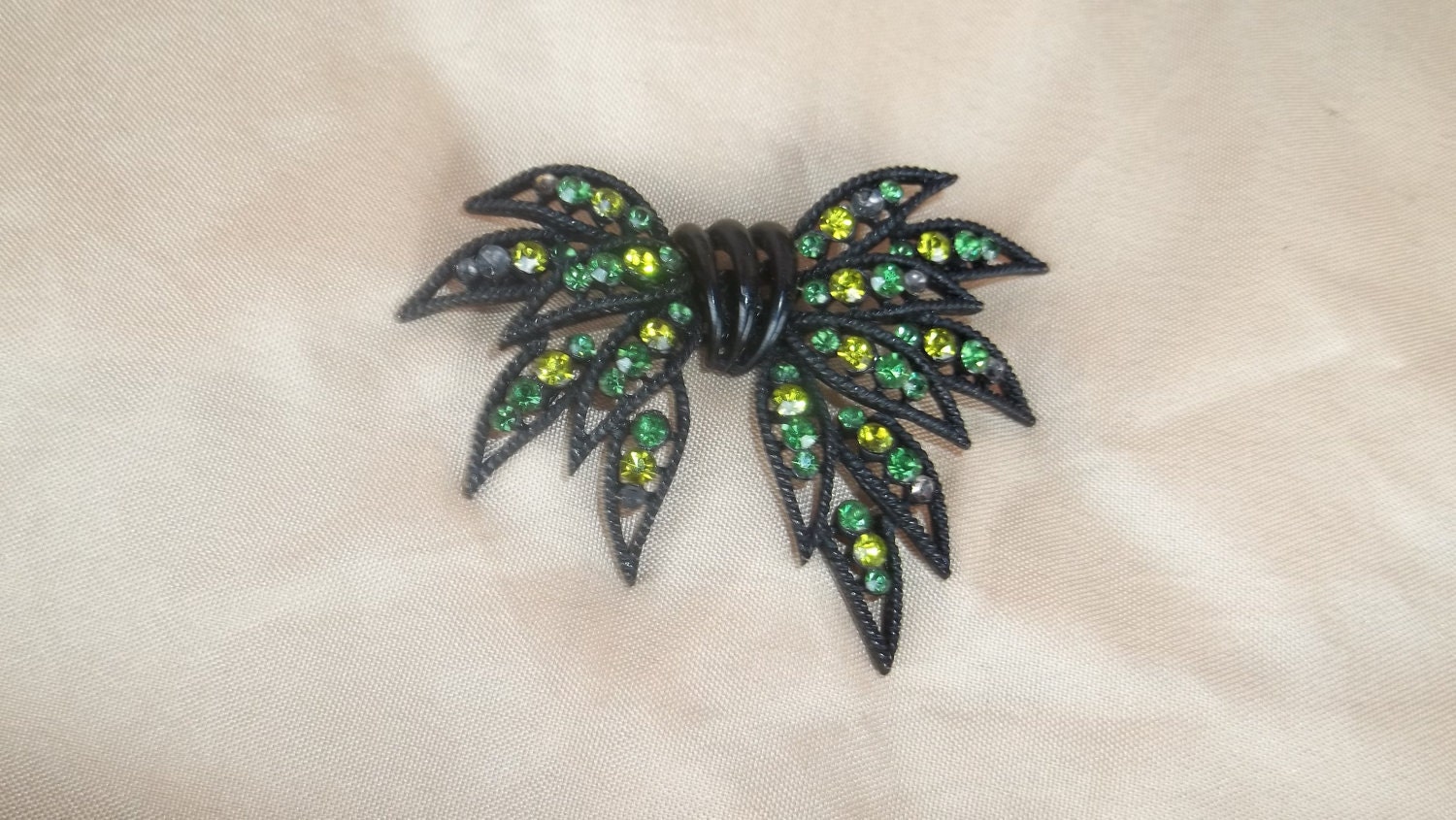 Black Bow Shaped Brooch with Green peridot colored stones  Treasured   Vintage