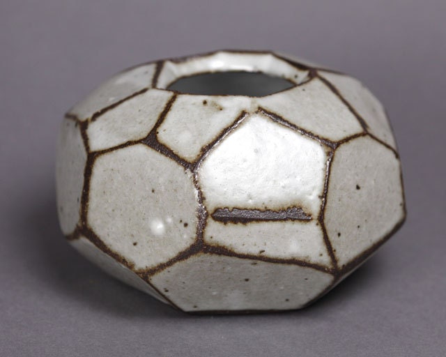 Faceted brown and white vase.