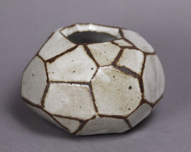 Faceted brown and white vase.